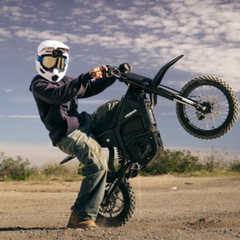 Yozma IN 10 Black Electric Dirt Bike Performing a Wheelie