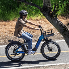 Woman riding a blue Heybike Horizon electric bike with a front basket.