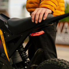 FreeGo Nova 4 Mid-Drive Electric Dirt Bike seat and rear brake light detail