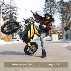 Rider performing a wheelie on a Classic yellow Heybike Villain.