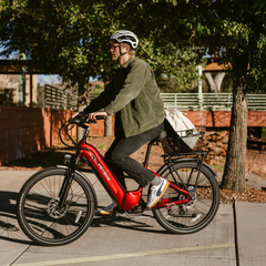 Rider using a red Heybike Hybrid electric bike on a paved path.