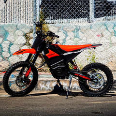 Yozma IN 10 Pro Red Electric Dirt Bike Parked by a Graffiti Wall