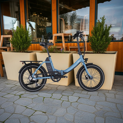 Blue Blix Vika X Folding eBike parked outside a café