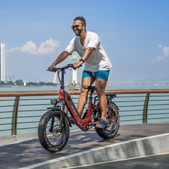 Rider using the red Heybike Ranger 3.0 Pro along a waterfront
