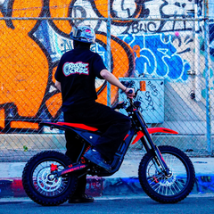 Yozma IN 10 Pro Red Electric Dirt Bike with Rider by a Graffiti Wall