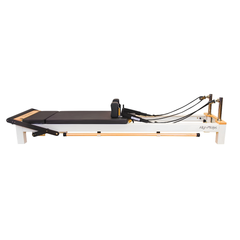 Align-Pilates C8-S Reformer side view showing full reformer frame, carriage, shoulder rests, footbar, and rope system