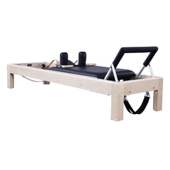 80-inch maple Pilates reformer with black carriage, shoulder rests, and footbar