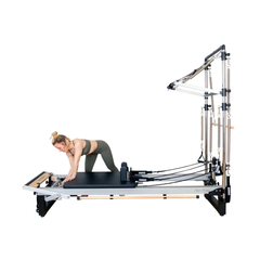 Align-Pilates Half Cadillac Frame (for A, M, C Series) attached to reformer in use for kneeling Pilates exercise