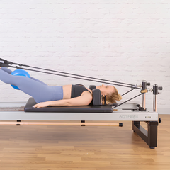 Align-Pilates A8-Pro Reformer 64cm Legs in use with leg straps for Pilates reformer exercise