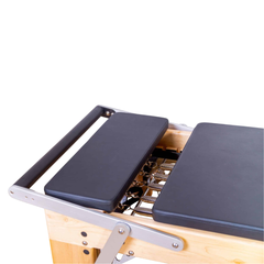 Align-Pilates M8 Pro Maple Reformer + Pro Sitting Box close-up showing padded carriage, footbar, and spring area