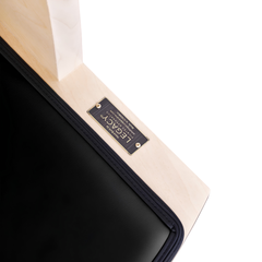 Close-up detail of Legacy Pilates Apparatus Maple Pilates Wunda Chair frame and upholstery