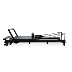 Align-Pilates C8-Pro Noir Reformer Black side view showing long black frame, carriage, shoulder rests, and rope system