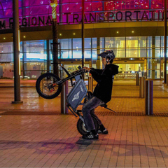 FreeGo X0 Electric Mini Bike black rider wheelie night view