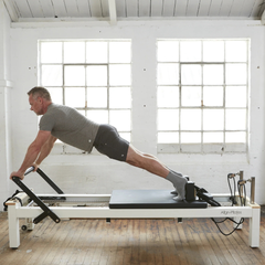 Align-Pilates C8-S Reformer in use for plank exercise with footbar support