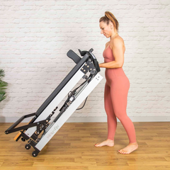 Align-Pilates F3 Folding Home Reformer being folded upright for storage