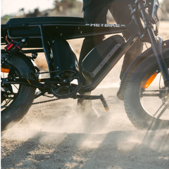 Close-up of the Saturn electric bike riding through dust on an off-road trail.