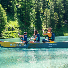 Aqua Marina - Tomahawk AIR-C 15'8" High Pressure Speed Canoe on clear water with three paddlers