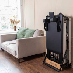 Align-Pilates F3 Folding Home Reformer folded upright for compact home storage
