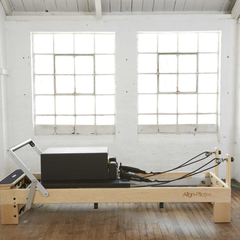 Align-Pilates M8 Pro Maple Reformer + Pro Sitting Box in studio setting showing full reformer setup
