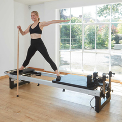 Align-Pilates A8-Pro Reformer Short 28cm Legs in use for standing Pilates reformer exercise in a studio setting
