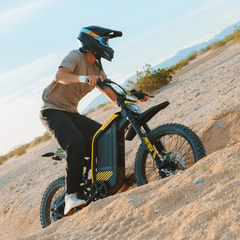 Rider climbing a sandy hill on the Jasion Patrol 52 electric dirt bike