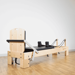 Align-Pilates M8 Pro Maple Reformer + Pro Sitting Box side view showing maple frame, carriage, shoulder rests, and footbar