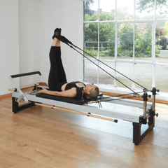 Align-Pilates A8 Pro Reformer (42cm/Standard legs) in use with leg straps for Pilates reformer exercise