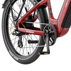 Close-up of the red Heybike Hybrid battery, crankset, pedals, and rear wheel.