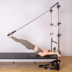 Align-Pilates Half Cadillac Frame (for A, M, C Series) in use with push-through bar for Pilates exercise