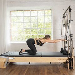 Align-Pilates M8 Pro Maple Reformer + Pro Sitting Box in use for kneeling Pilates reformer exercise