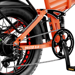 Close-up of the orange Mars 3.0 crankset, chain, and folding frame.