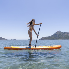 Aqua Marina AMgo Turbo 366 with BlueDrive S Power Fin Set on water with person paddle boarding