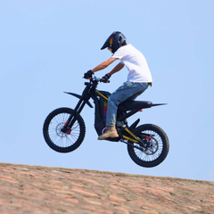 FreeGo Nova 4 Mid-Drive Electric Dirt Bike rider jump action view