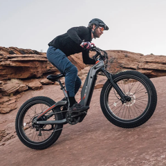 Rider climbing a rocky trail on the Heybike Hero electric bike.