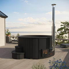 Black outdoor fireplace on a wooden deck with ocean view