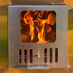 Metallic stove with flames inside on a reflective surface
